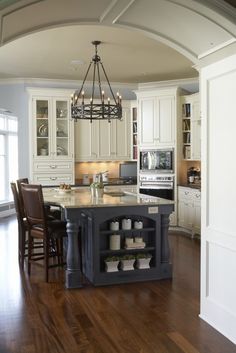 a large kitchen with an island in the middle