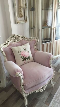 a pink chair sitting on top of a hard wood floor