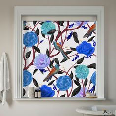 a bathroom window with blue flowers and birds on it