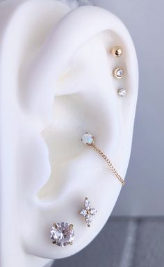 an ear with three piercings attached to it