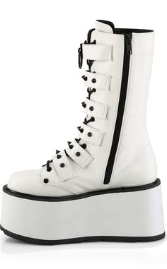 Dayum! The DAMNED-225 mid-calf platform boots are perfect for those who want some height with their stompy af boots without having to totter around on a heel. 6 studded buckled straps sit over full-length lace-ups with black trims on the white body creating a stunning contrast. SLip in n' out in a snap with the full-length inner zip. The DAMNED series features a 3 1/2 inch flatform. Material: 100% vegan PU leather. US women's sizing-refer to size chart for more info. Demonia Damned 225, Hologram Shoes, Emo Boots, Boots With Platform, White Platform Boots, Leather Mid Calf Boots, Punk Festival, Demonia Boots, White Gothic