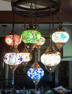 a chandelier with many different colored lights hanging from it's sides in a kitchen