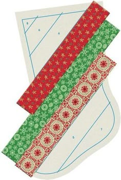 two pieces of paper with red and green designs on the bottom, one is folded in half