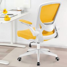 an office chair with yellow upholstered seat sits in front of a white desk