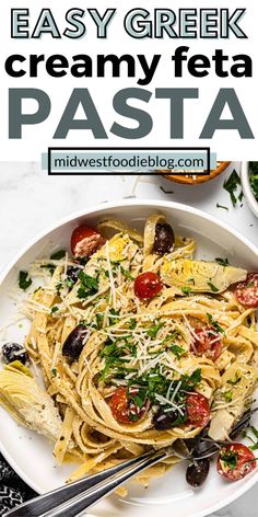 a white plate topped with pasta and olives