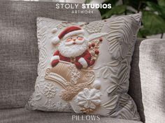 a santa clause pillow sitting on top of a couch next to a chair with the caption story studios artwork pillows