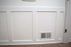 a white door with a vent in it