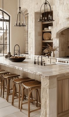 a large kitchen island with stools next to it and an oven in the background