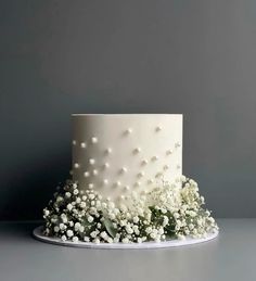 a white wedding cake with baby's breath flowers