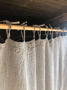 a white curtain hanging from a wooden rod