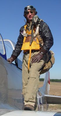 a man standing in the cockpit of an airplane