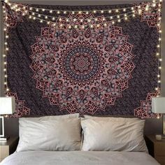 a bed topped with a large tapestry covered in lights