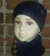 a mannequin head wearing a black knitted hat and scarf with gold buttons