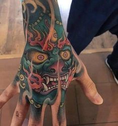 a person's hand with a tattoo on it