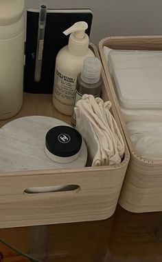 an assortment of personal care items are sitting on a table with bottles and containers in the background