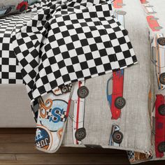 a bed topped with a checkered comforter and pillows