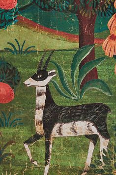 an animal painted on the side of a wall next to trees and flowers in a field