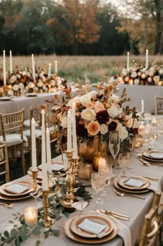 an elegant table setting with candles and flowers