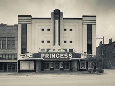 black and white photograph of an old movie theater with the word princess written on it