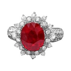 an oval shaped ruby and diamond ring with white diamonds on the sides, set in 18k white gold