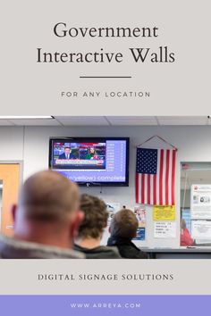 people are watching television in an office with the words government interactive walls for any location