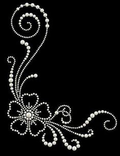 an embroidered design with pearls and swirls