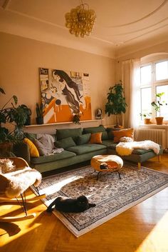 a living room filled with lots of furniture and decor on top of a hard wood floor