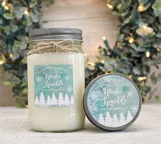 a candle with a label on it sitting next to a wreath