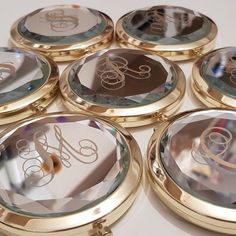 six personalized compact mirrors with monogrammed initials on them are shown in gold