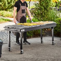 a man cooking donuts on an outdoor grill