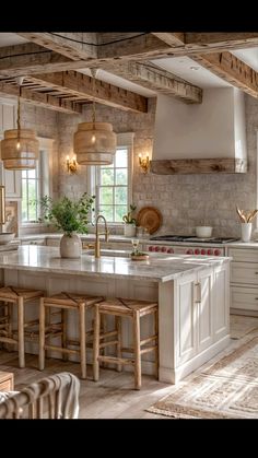 a large kitchen with white cabinets and wooden beams