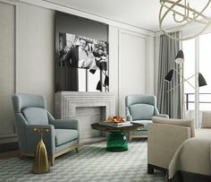 a living room filled with furniture and a chandelier hanging from the ceiling over a fire place