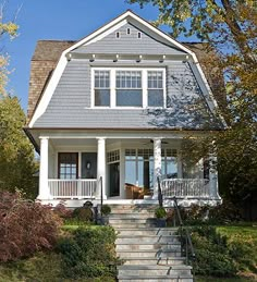 a house with stairs leading up to the front door