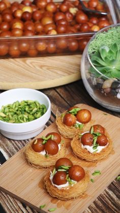 some food is sitting on a cutting board next to other foods and vegetables in bowls