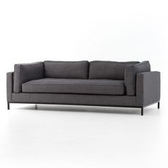 a gray couch sitting on top of a white floor