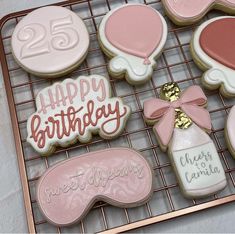 decorated cookies on a cooling rack with pink and white icing for 25th birthdays