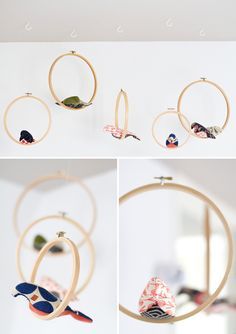 three pictures of birds hanging from the ceiling and in circular hoops with hooks on them