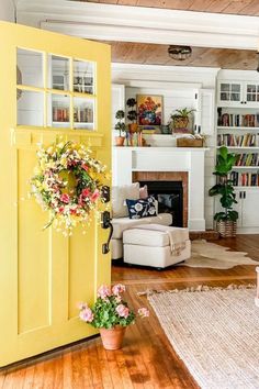 a living room filled with furniture and a fire place next to a book shelf full of books