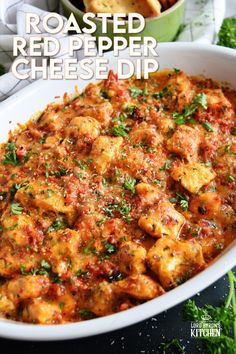 roasted red pepper cheese dip in a casserole dish with parsley on top