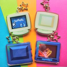 three key chains with different types of electronic devices attached to them on a multi - colored background