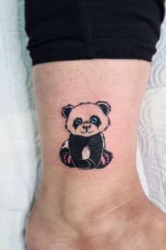 a small panda bear tattoo on the ankle