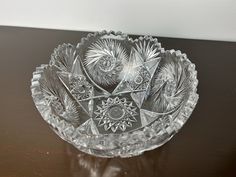 a glass bowl sitting on top of a wooden table