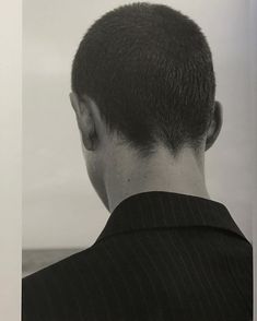 the back of a man's head is shown in black and white