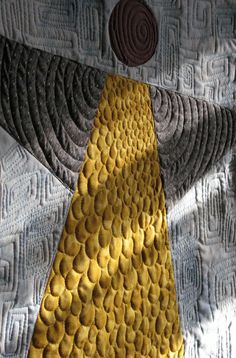 a close up of a yellow tie on a piece of fabric with circles and lines