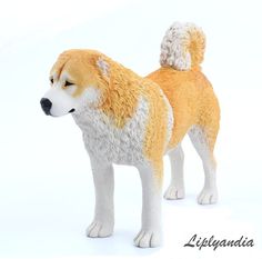 a toy dog is standing on a white surface with its head turned to the side