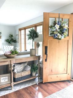 a living room filled with lots of furniture and flowers on top of a wooden table