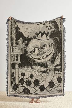 a black and white tapestry with an image of a cat wearing a hat on it's head