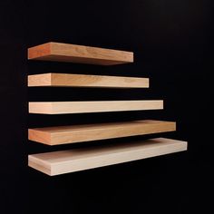 three wooden shelves are stacked on top of each other