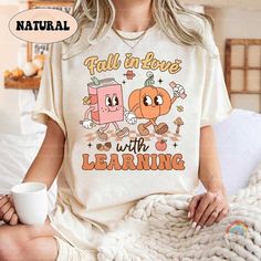 Teacher Shirt Fall In Love With Learning, Teacher Pumpkin Fall Shirt Halloween Spooky Shirt, Teacher Thanksgiving Sweatshirt, Back To School ↓ Click here to view our additional fashionable collections  https://handcraftedbyhelenn.etsy.com Product Details: - 100% Cotton (fiber content may vary for different colors) - Medium fabric (5.3 oz/yd2 (180 g/m2)) - Classic fit - Tear away label - Runs true to size Care instructions: - Machine wash: warm (max 40C or 105F); - Non-chlorine: bleach as needed; Teacher Thanksgiving Shirts, Funny White T-shirt For Fall, Cute Fall T-shirt For Gift, Cute Pre-shrunk Shirt For Fall, Cute Short Sleeve Fall Shirt, Cute Short Sleeve Shirt For Fall, Casual Fall Shirt With Cartoon Print, Cute Fall Crew Neck Shirt, Cute Crew Neck Fall Shirt