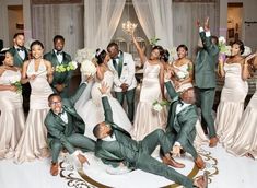 a group of people standing and sitting around each other in front of a wedding cake